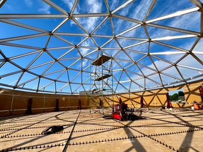 Technicians performing repair and retrofit work on an existing bolted steel storage tank system
